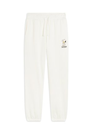 Pantalons de jogging couleur crème avec taille élastique, cordon de serrage et poignets côtelés. Présente un graphique de Snoopy sur la cuisse gauche.