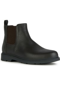 Botín Chelsea de cuero negro con paneles laterales elásticos, superficie texturizada, punta redondeada y suela de goma para mayor agarre. Diseño minimalista.