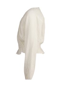 Blusa bianca a maniche lunghe con effetto stropicciato e vita stretta, caratterizzata da maniche voluminose e una leggera riga al fondo. Tessuto testurizzato.