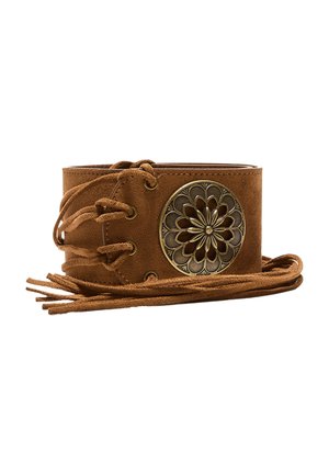 Cintura in suede marrone con lati stringati e una medaglia rotonda in ottone con un motivo floreale intagliato.