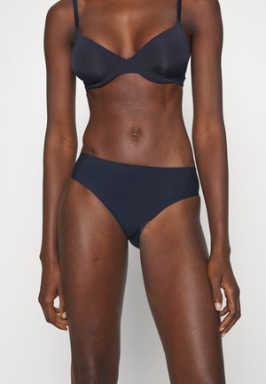Navy blue bikini set featuring a underwired bra with thin straps and a low-rise bottom. Material appears smooth, with minimalistic design.