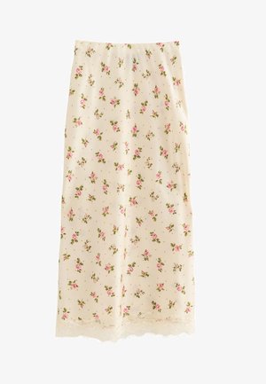Jupe midi de couleur crème avec motif floral de roses roses et bordure en dentelle le long de l'ourlet, coupe droite et texture lisse.