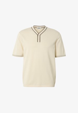 Cream short-sleeve shirt with brown trim on V-neck collar and sleeve edges, featuring two buttons below the neckline.