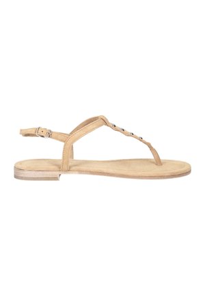 Tan suede sandal with a minimalist design. Features adjustable ankle strap, toe loop, and silver-tone decorative accents. Flat sole.