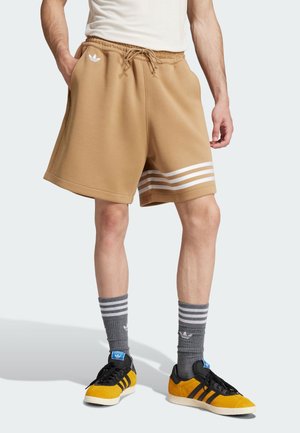 NEUCLASSICS - Tracksuit bottoms - cardboard