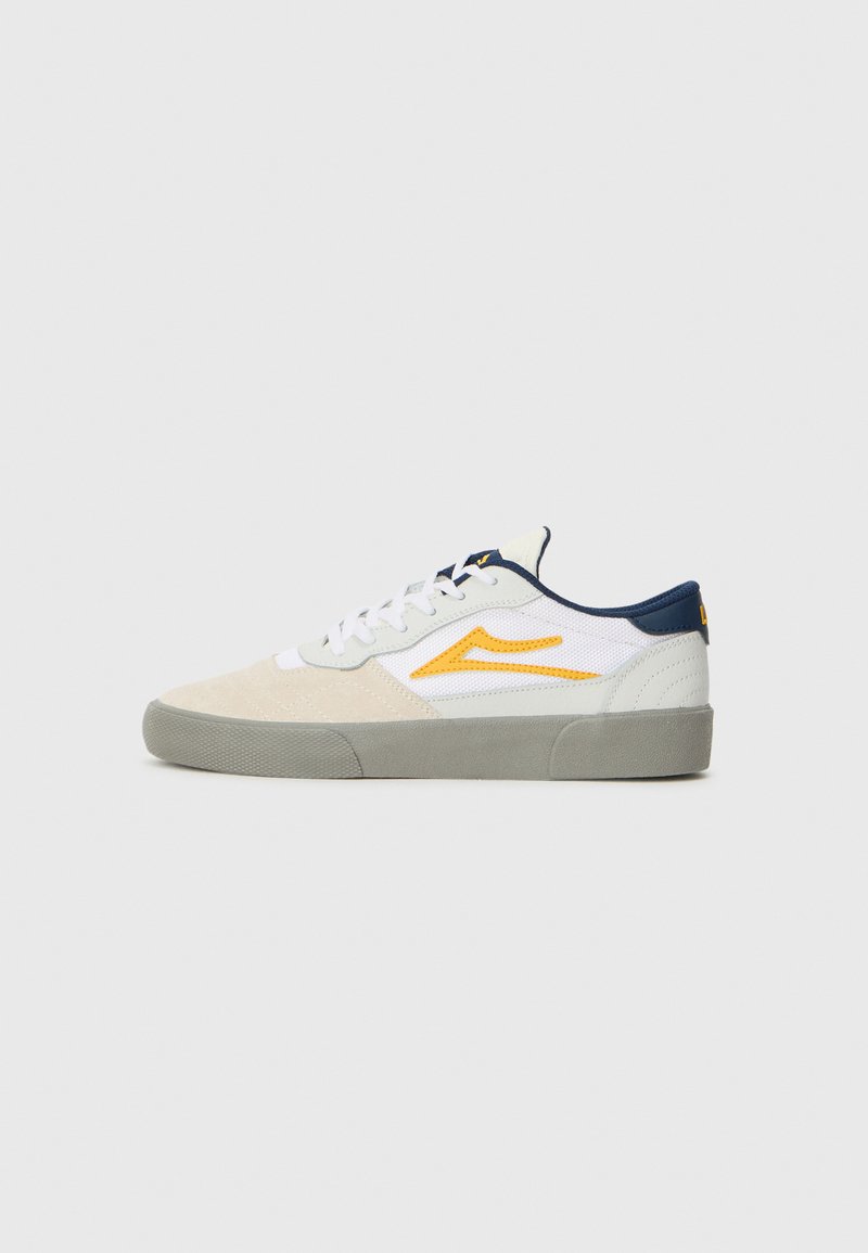 White and beige sneakers with a suede and mesh upper, grey rubber sole, yellow accents, and navy blue trim. Features lace closure.