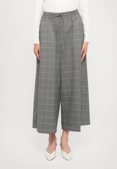 Grau karierte weite Hosen mit elastischem Bund und Kordelzug. Hat subtile Farbvariationen und eine leichte Stofftextur.