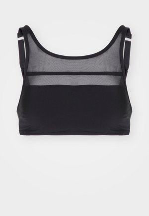 Črn športni modrček z mehkobo tkanine, ki vključuje mrežaste panele na vrhu. Ima okrogel izrez in široke naramnice za podporo.