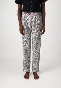 Floral pyjamabroek met een witte achtergrond, voorzien van blauwe en roze bladeren, rechte snit, elastische tailleband met een roze koord.