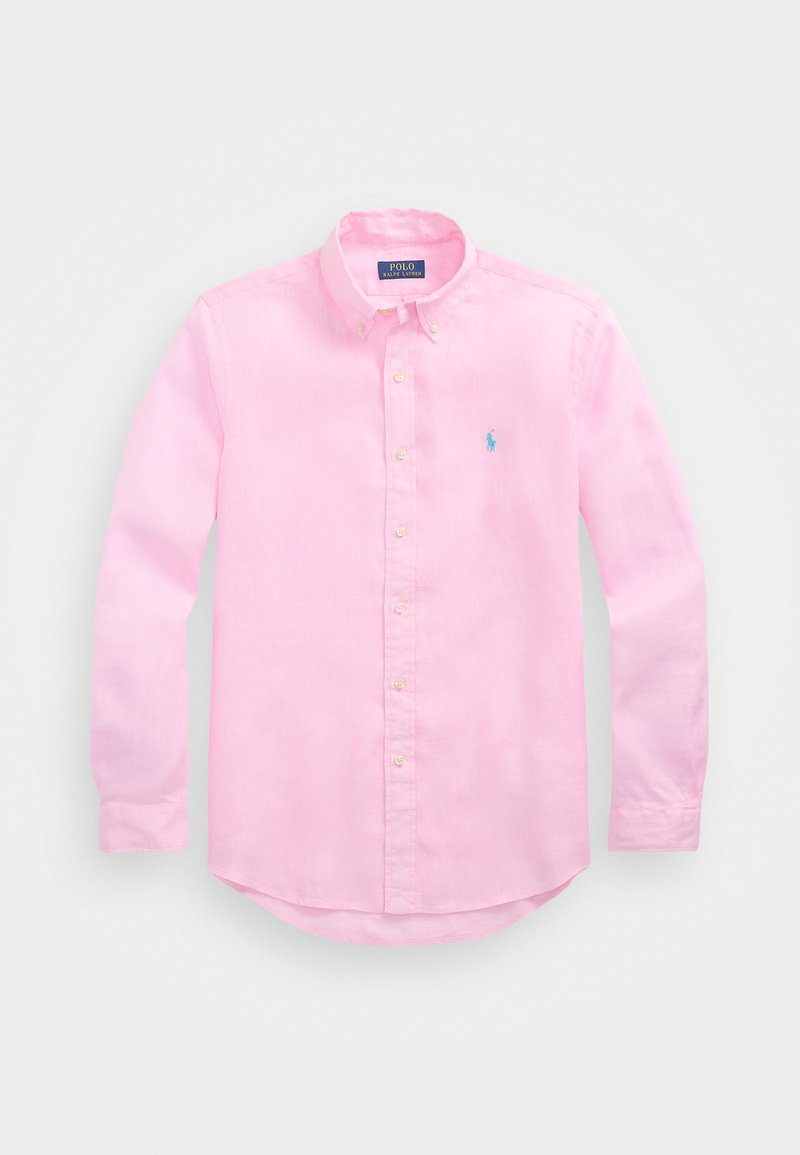 Lys rosa knapp-til-bunnen skjorte laget av bomull, med krage, lange ermer, og en liten blå logo på brystet. Myk tekstur.