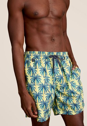 Un maillot de bain avec un fond jaune et des motifs de palmiers bleus. Comprend une taille élastique et des poches latérales.