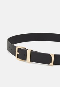 Black leather belt with a smooth texture, featuring a gold metal buckle and an additional rectangular gold accent. Multiple hole adjustments.