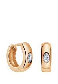 Złote kolczyki w kształcie obręczy charakteryzujące się gładkim, zaokrąglonym wzornictwem, z przezroczystym owalnym kryształem na każdej parze. Polerowane wykończenie.