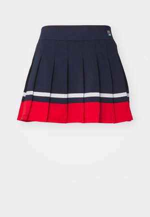 Navy pleated skirt with a wide waistband, featuring red and white horizontal stripes at the hem and a logo tag on the waistband.