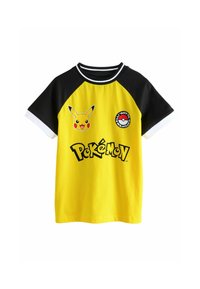 Keltainen t-paita mustilla raglan-hihnoilla. Sisältää Pikachu-kuvaston ja Poké Ball -patchin. "Pokémon"-logo tulostettuna mustalla. Puuvillamateriaali.