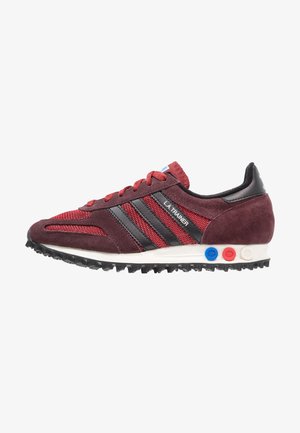 Maroon retro sneaker with mesh and suede upper, black stripes, textured sole, red laces, and multicolor accents on the heel.