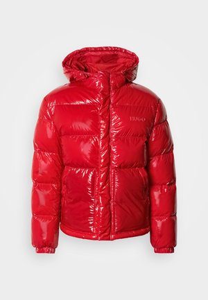 Red puffer jacket with a glossy finish, padded design, attached hood, zip closure, and "HUGO" logo on the chest. Elastic cuffs and hem.