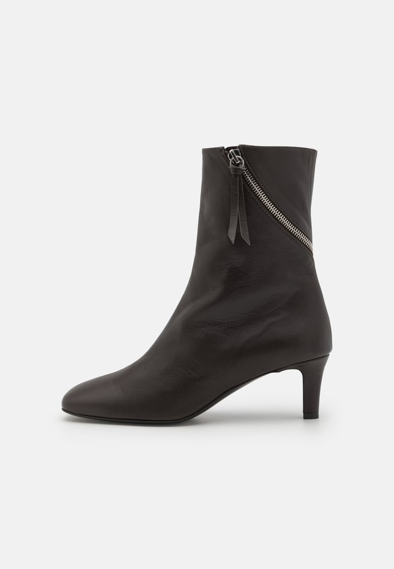 Black leather ankle boot with a pointed toe and a short, cylindrical heel. Features a diagonal zipper with a tassel accent.