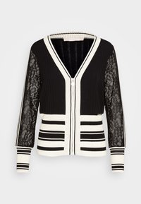 Svart och vit randig cardigan med genomskinliga blommiga spetsärmar, ribbad stickad kropp, dragkedja fram och V-ringad krage.