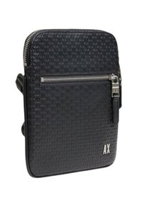 Black textured shoulder bag with a zippered front pocket and silver hardware. Features an embossed pattern and a logo on the side.