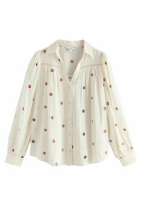 Embroidered blouse in cream fabric, featuring colorful floral patterns, a button front, and long, puffed sleeves with a collar.