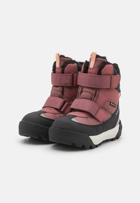 Pink and black winter boots with Velcro straps, textured fabric, faux fur lining, and a rugged sole for traction on snow and ice.