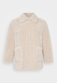 Beige faux fur coat featuring a collared neckline, long sleeves, and two front pockets. The texture is soft and fluffy.