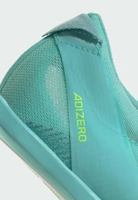 Turquoise running shoe with a mesh upper, smooth accents, and "ADIZERO" branding in bright yellow. Lightweight design ideal for performance.