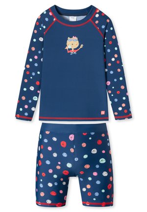 Navy blue swim set featuring long-sleeve top with colorful polka dots and a cat graphic, matched with shorts of the same pattern.