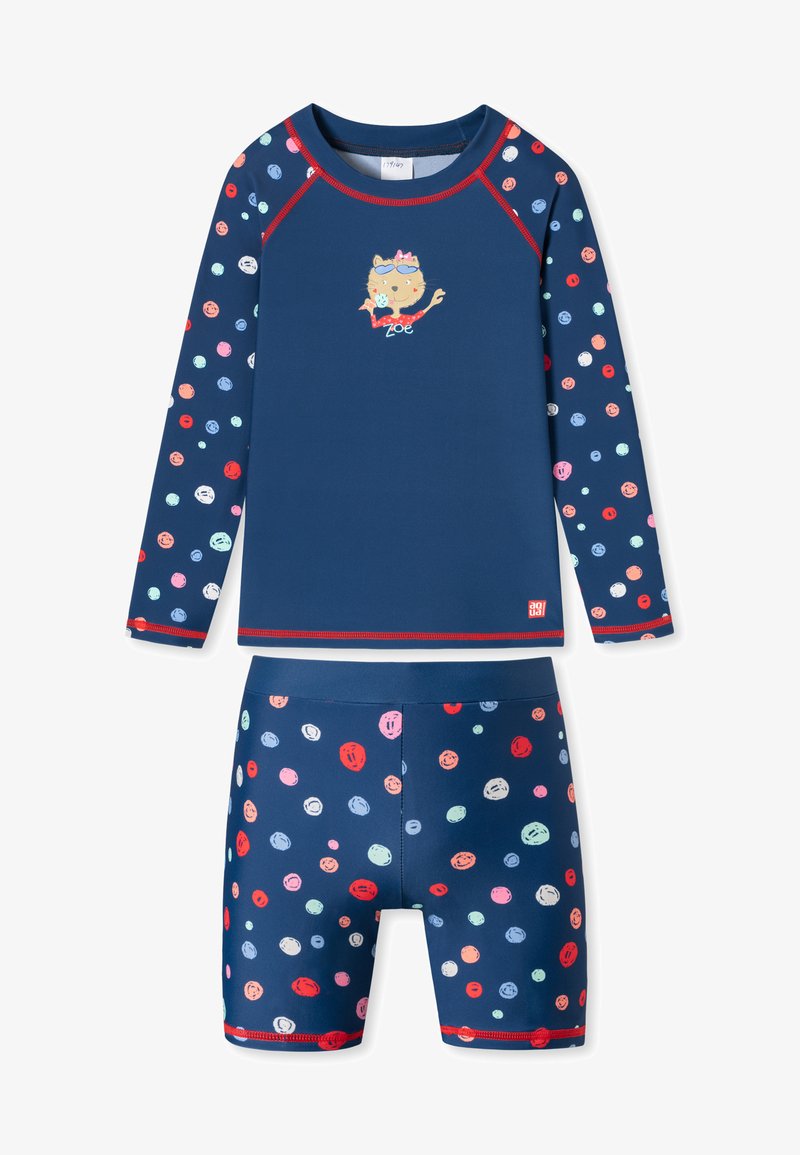 Marineblauwe zwemset met een top met lange mouwen, versierd met kleurrijke stippen en een kattenafbeelding, gecombineerd met shorts in hetzelfde patroon.