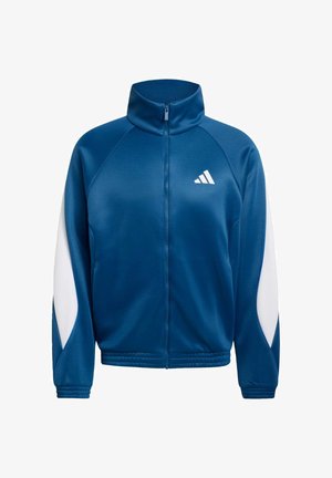 Giacca sportiva blu con zip, pannelli bianchi sulle maniche, collo alto, polsini ed orlo elasticizzati, e piccolo logo Adidas bianco sul petto.