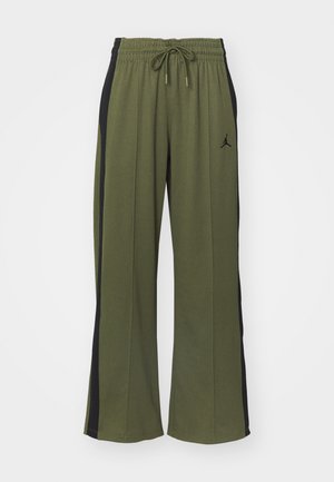 Green track pants with black side panels, elastic waistband, and drawstring. Features a small black logo on the left leg. Soft fabric texture.