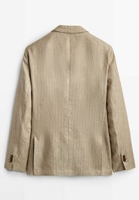 Beżowa lniana marynarka o czystym kroju, z pojedynczym rozcięciem z tyłu i mankietami na guziki. Tekstura jest gładka z subtelnym połyskiem.