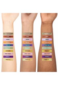 Tres brazos muestran muestras de varios colores brillantes, etiquetados con nombres, que van desde tonos de piel claros hasta tonos más oscuros, destacando la diversidad.