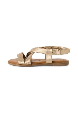 Metallic gold flat sandals with crisscross straps and an adjustable ankle strap. Natural leather footbed and rubber sole.