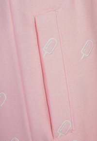 Hellrosa Stoff mit Taschendetail, verziert mit weißen gestickten Eis am Stiel-Mustern. Glatte Textur mit sanfter Haptik.