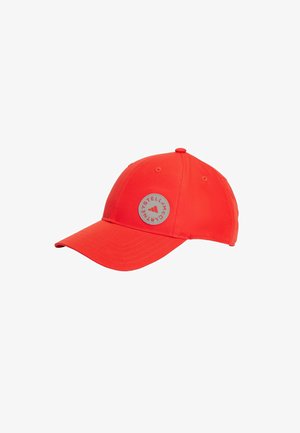 Red baseball cap with a curved brim, featuring a circular logo patch and tonal stitching. Made of smooth fabric with eyelet details.