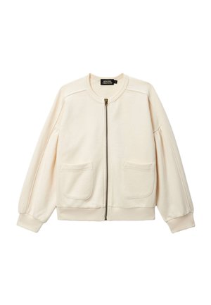 Veste zippée couleur crème avec manches longues bouffantes, deux poches avant, poignets et ourlet côtelés.