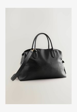 Black leather handbag with dual top handles and an adjustable crossbody strap. It features a smooth texture and gold-tone hardware accents.