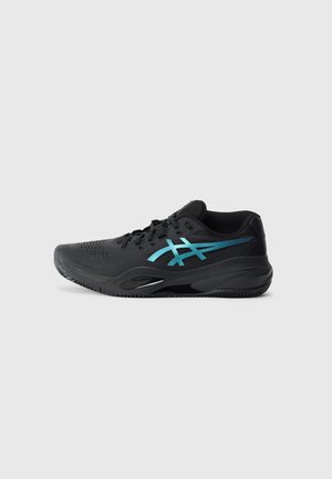 Black athletic shoe with blue logo on side, featuring lace-up front and textured sole for traction, shown on a plain white background.