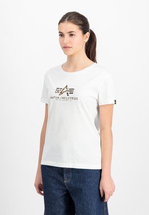 White cotton t-shirt featuring a brown and black graphic design with "ALPHA INDUSTRIES" text. Short sleeves and round neckline.