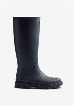 Botas de chuva de borracha azul-marinho com textura suave, cano alto, sola robusta e um pequeno emblema de logotipo perto do topo.