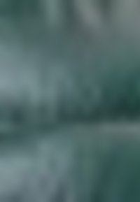 Vervaagd abstract beeld met verschillende tinten teal en grijs, met subtiele texturen die een zachte, gradient effect creëren.