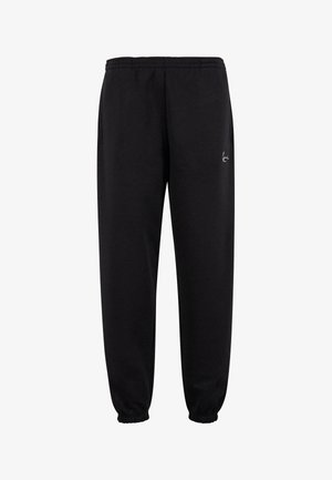 Sorte sweatpants med elastisk talje, sidelommer og elastiske bærestropper. Har et lille hvidt logo på det øverste lår. Glat tekstur.