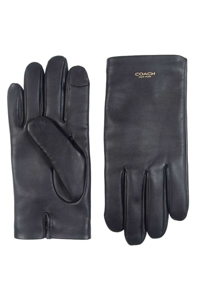 Gants en cuir noir avec une texture lisse, comportant cinq doigts et un pouce séparé, marqués "COACH" en or au niveau du poignet.