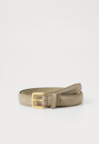 Beige mokkanahka vyö kultaisella metallisoljella. Ominaisuuksina sileä pinta ja brändin yksityiskohtia painettuna vyölle.