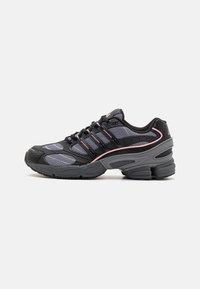 Black and gray athletic shoes with mesh panels, pink accent lines, and a chunky sole design. Features laces and textured material details.