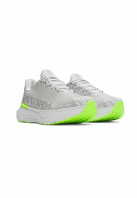 Light gray athletic shoes with a textured upper and bright green outsole. Features a cushioned sole and lacing system for secure fit.