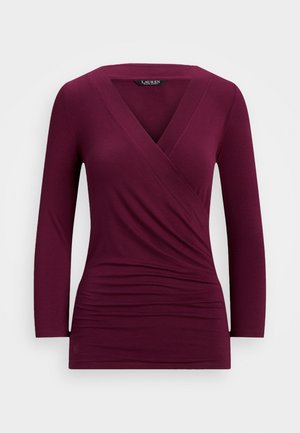 Langarmige, dieppaars wikkelblouse met gerimpelde zijkanten en een V-hals.