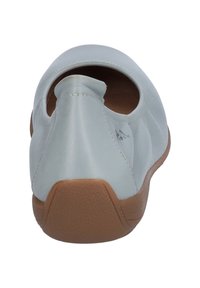 Light blue leather shoe with a rounded back, tan rubber sole, and a stitched seam detail along the upper edge. Open at the heel.
